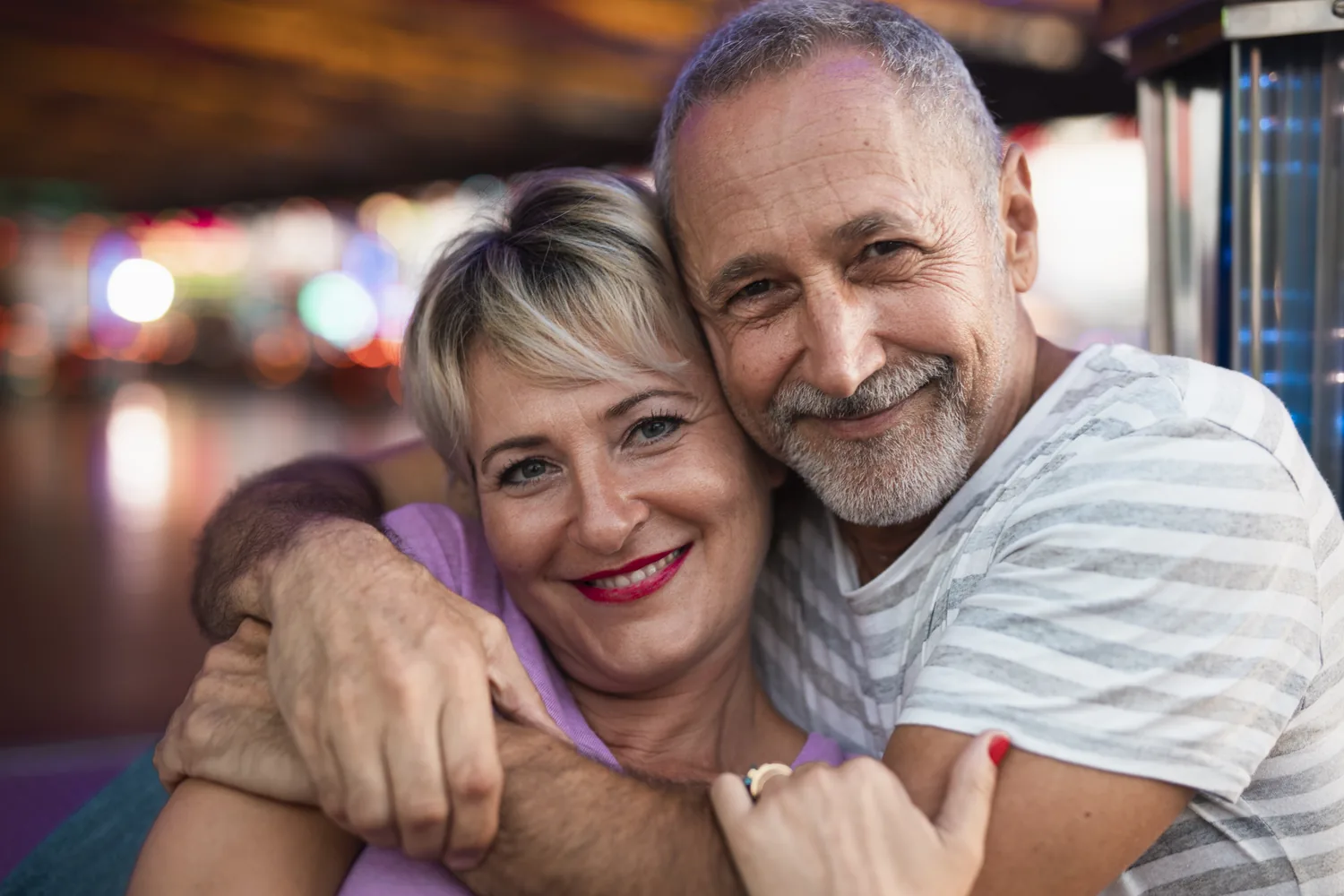 Mature adults enjoying an evening embrace, showing the pleasure of romance without assuming a future promise