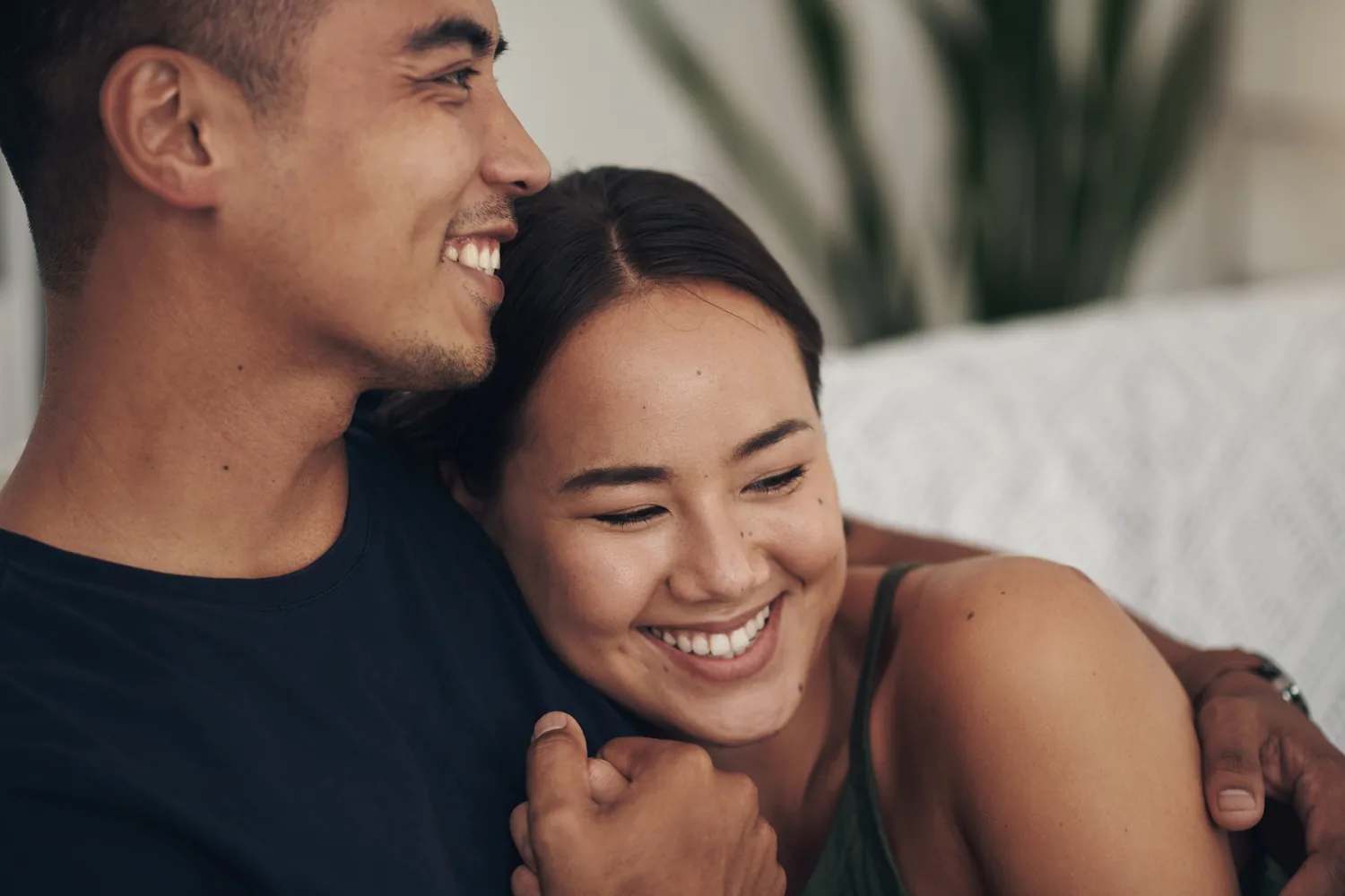 A couple smiling together at home, illustrating ordinary affection while trust develops after disclosure
