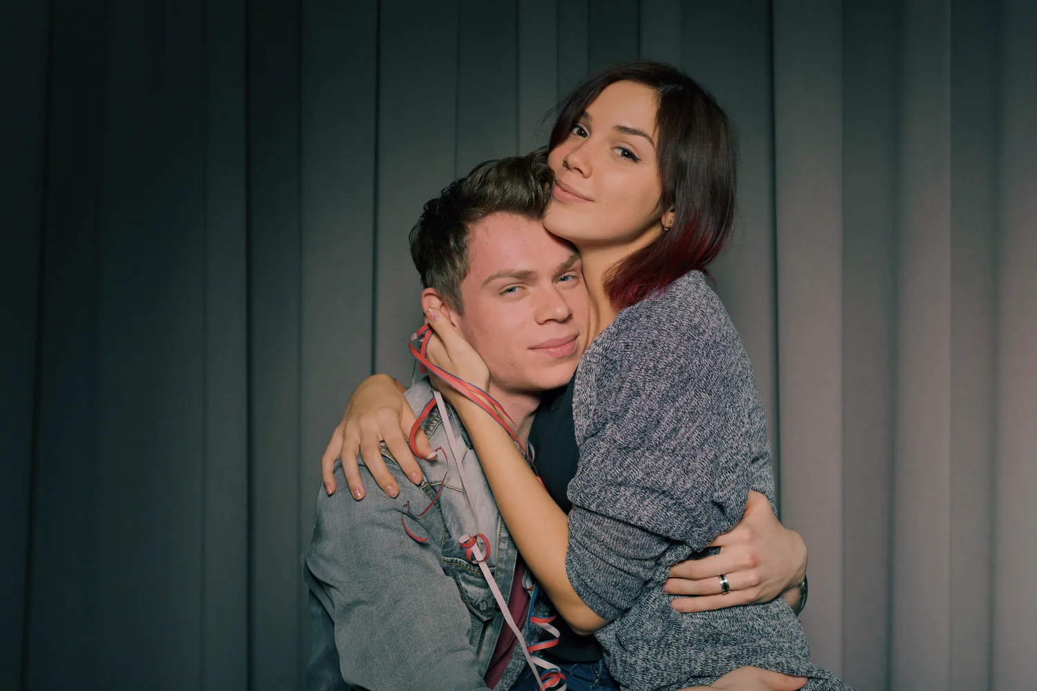 Two adults embracing indoors, illustrating a relationship conversation about genital HSV-1 and intimacy