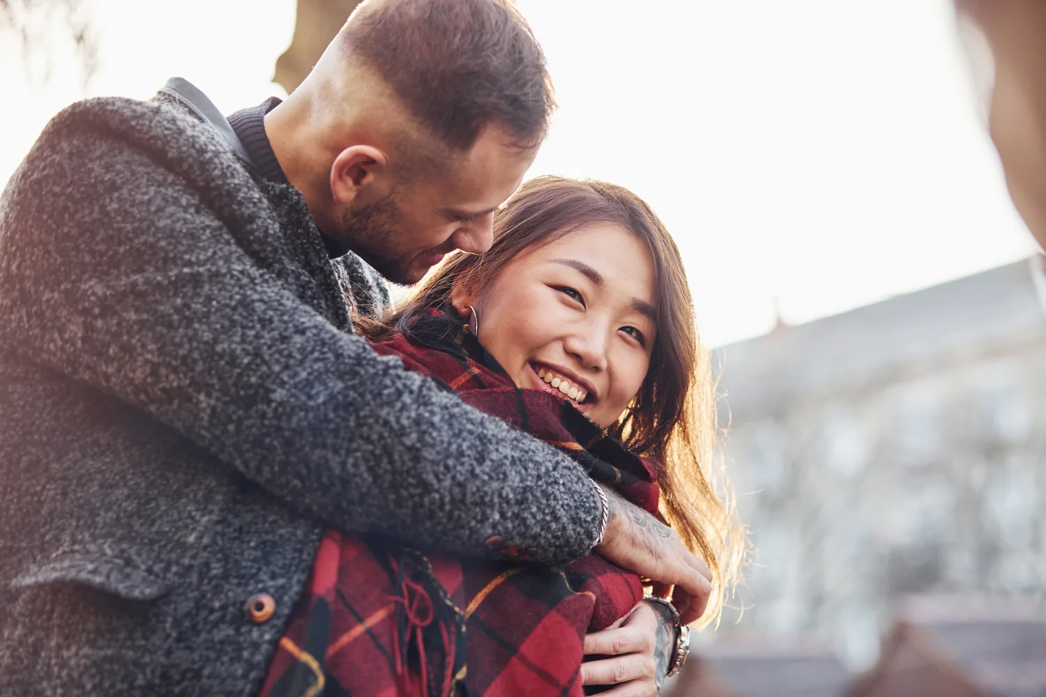Two adults sharing a winter embrace, reflecting closeness alongside informed choices about HSV transmission