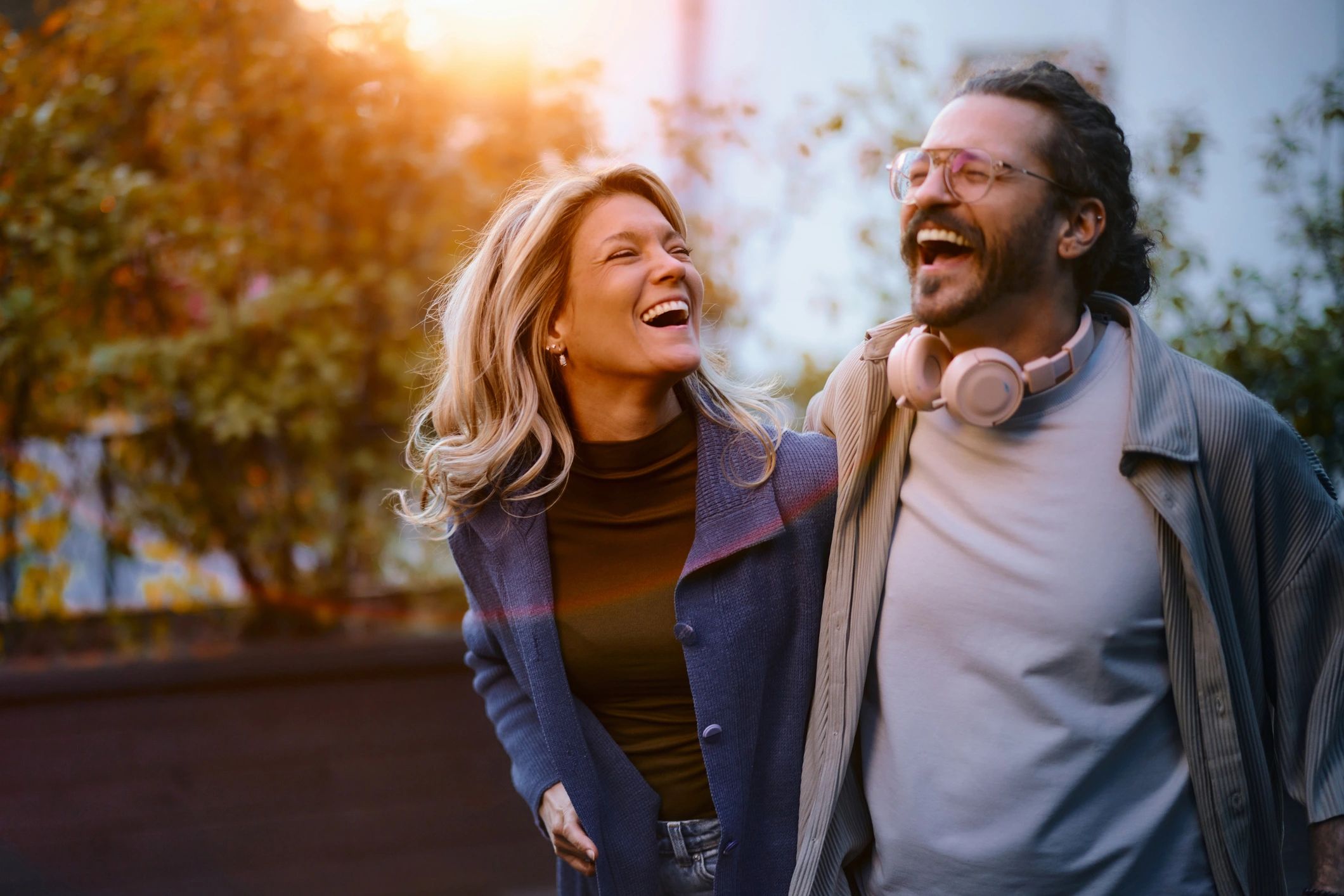 Happy couple laughing together outdoors